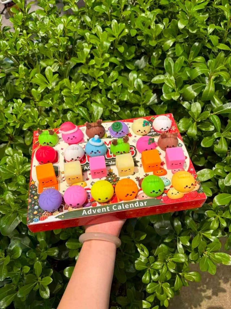Aventoh Christmas advent calendar shown in hand for scale with assorted mini squishy surprises
